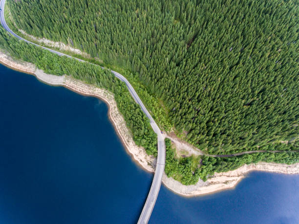 istock Road bridge over lake and mountain forest aerial view 826289250
