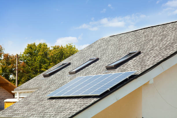 istock Solar water panel heating on new house roof with skylights against blue sky 826291778