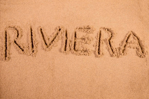 istock Riviera written in soft wet sand on a beach 826291868