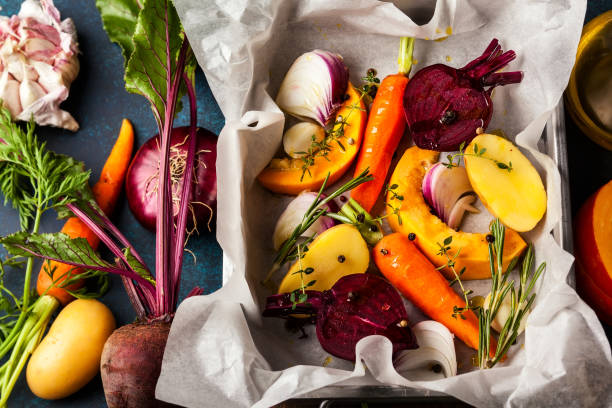 vegetables Preparing roasted vegetables with garlic and herbs on the baking tray. Autumn-winter root vegetables. winter food top view stock pictures, royalty-free photos & images