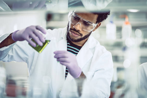 istock Scientist Pouring Reagent into Test tube 826292996