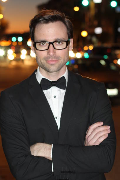 istock Sexy man in tuxedo and bow-tie posing 826293386