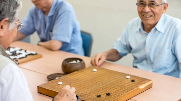 istock Retired men enjoying Go bord game in free time together 826301282