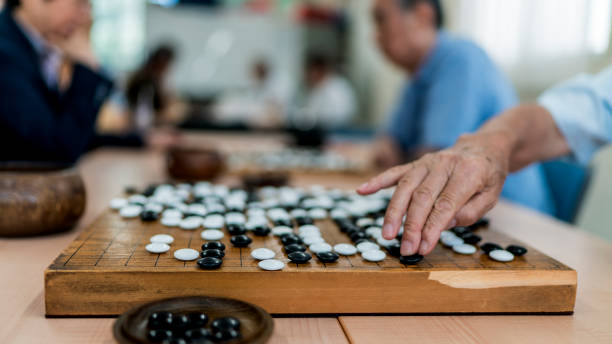 istock Putting a black small stone on a Go game bord 826301312