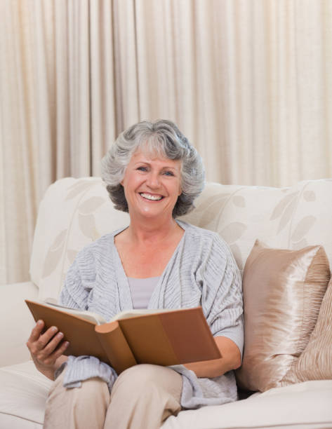 istock Senior looking at her photo album 826305018
