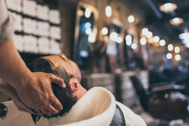 Photo of hairstylist washing clients hair
