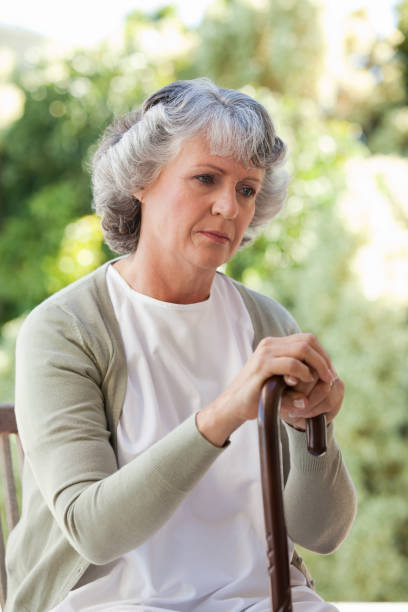 istock Retired woman with her walking stick 826308130