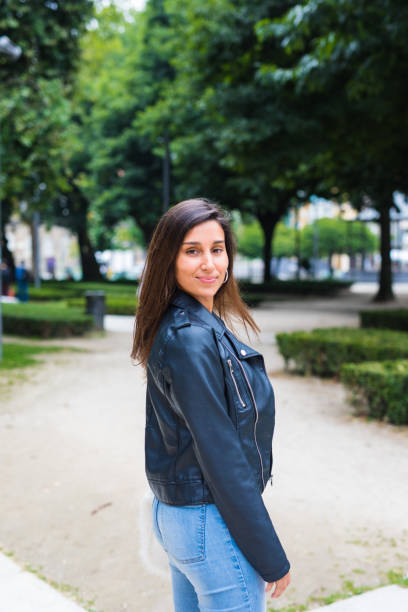 istock Young woman walking in the park 826308590