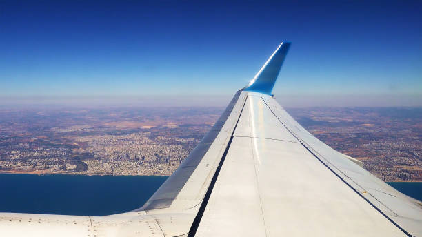 istock Plane is flying along the sea coast after takeoff 826311668