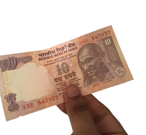 istock Hand holding 10 rupees Indian notes against white background 826319346