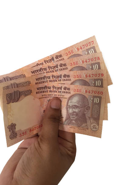 istock Hand holding 10 rupees Indian notes against white background 826320550