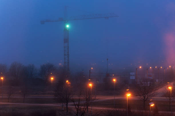 istock Tower crane and illumination at night, construction site 826350750
