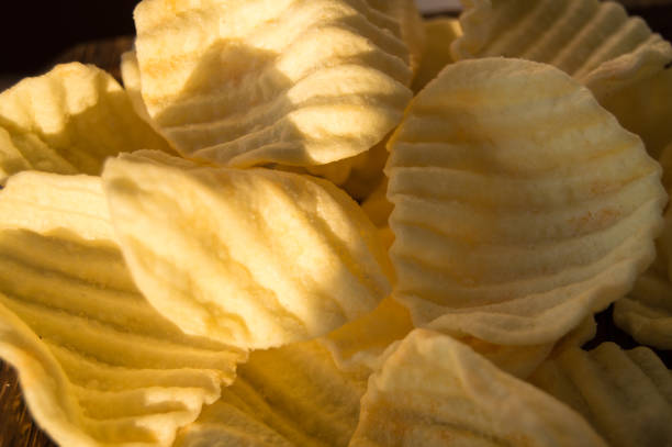 istock Yellow delicious salty potato chips in the background 826358060