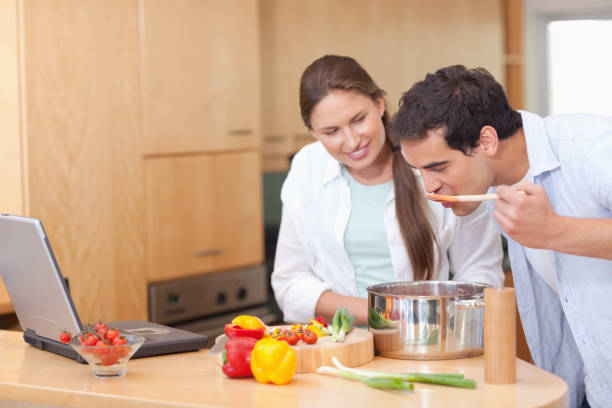 istock Gourmet couple using a laptop to cook 826359162