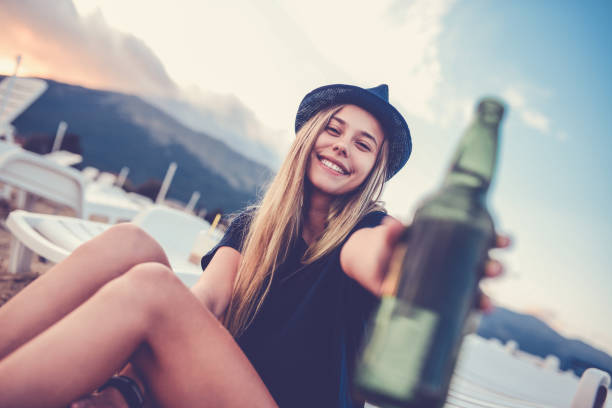 Young Smiling Girl Toasting On Beach at Dawn