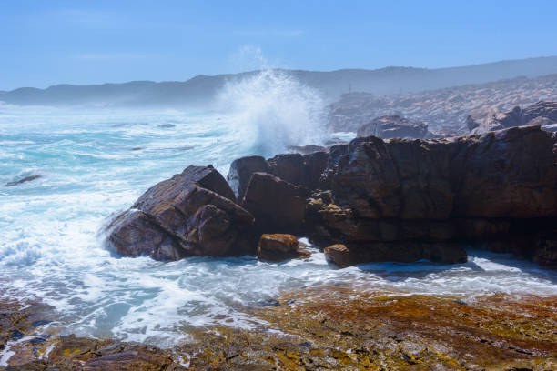 istock Ocean water hits against the stones 826361764