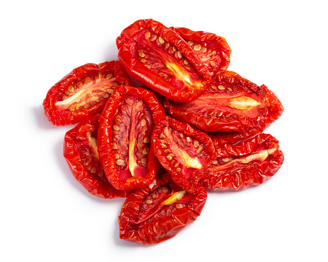 Pile of sundried or dried tomato halves, top view. Clipping paths, shadow separated