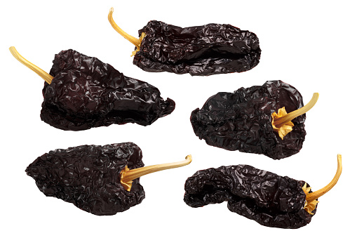 Ancho mulato - dark dried Poblano chile peppers, whole. Clipping path for each pod