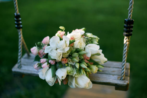 istock Bridal bouquet is on a swing 826370796