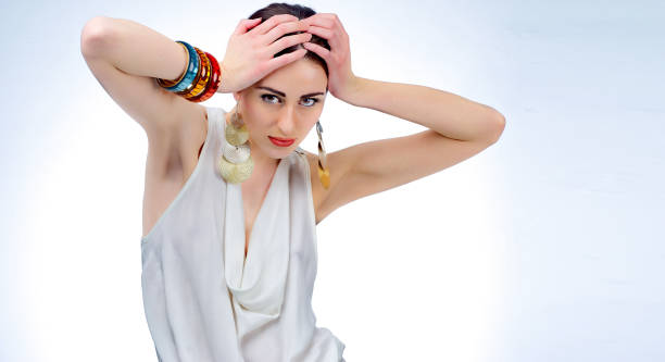istock Pretty woman posing at studio with white dress 826373588