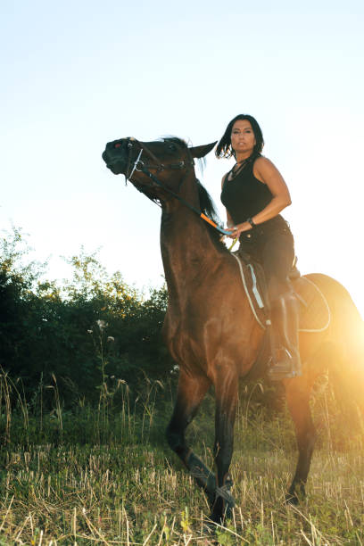 istock Woman riding her horse 826378206