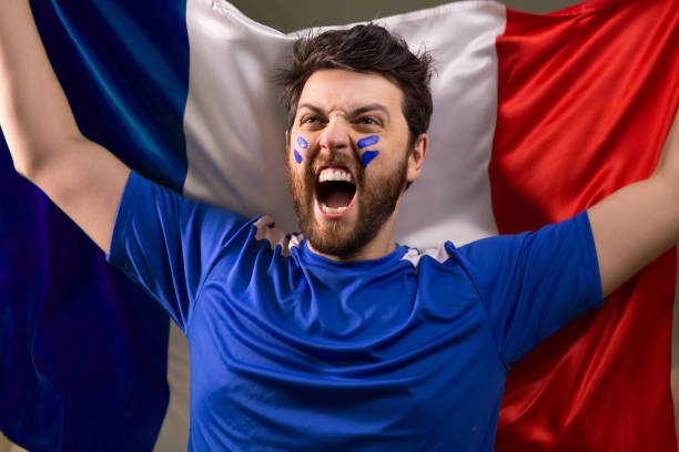 istock French fan holding the national flag 826380806