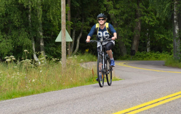 istock Woman bicycling on road 826381606