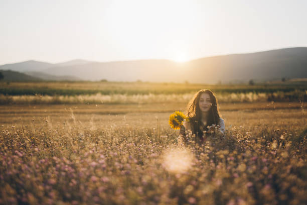 istock Hipster woman in wheat field in sunset 826384874