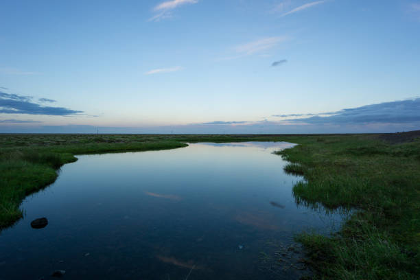 istock Iceland - Reflecting clouds and sky in twilight mood with awesome landscape 826389916