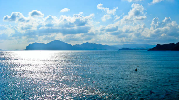 panorama of the sea with dense clouds and mountains
