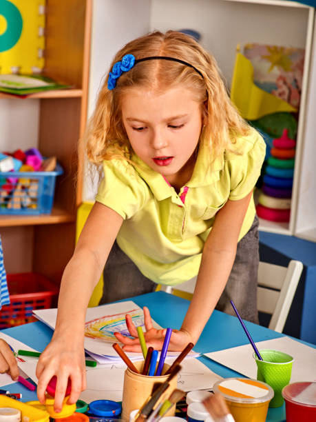 istock Small students children painting in art school class. 826413302