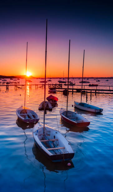 Sunset at Sandbanks in Dorset Beatiful rich colourful scene as the sun sets in Poole Harbour around the Sanbanks peninsula poole harbour stock pictures, royalty-free photos & images