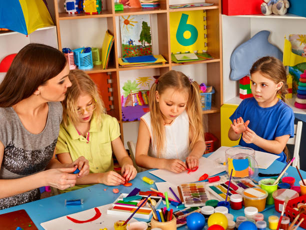 istock Plasticine modeling clay in children class. Teacher teaches in school. 826419518