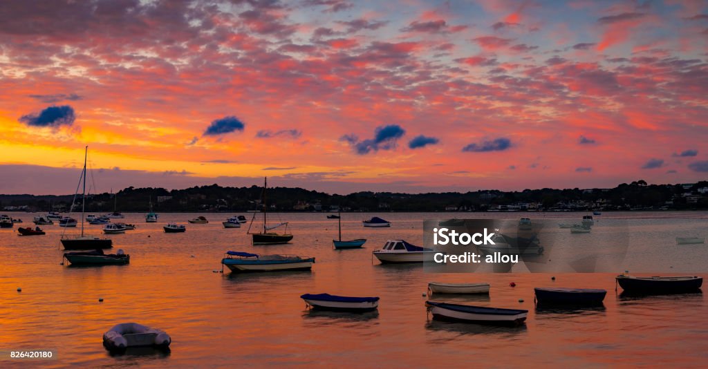 Sunset at Sandbanks in Dorset Beatiful rich colourful scene as the sun sets in Poole Harbour around the Sanbanks peninsula Bournemouth - England Stock Photo