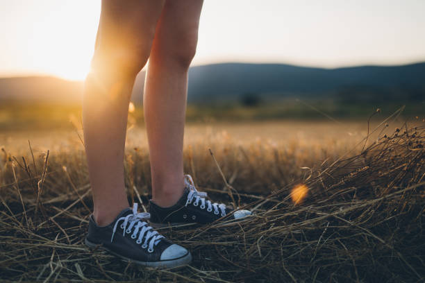 Young cute hipster woman standing in wheat field