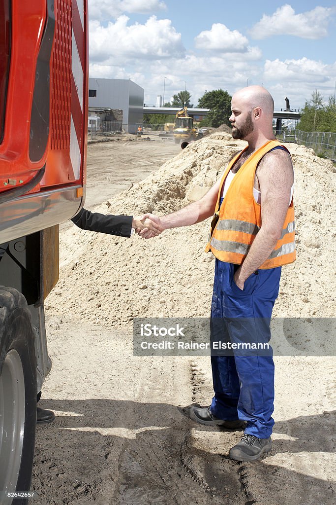 Construction worker and woman shaking hands  Construction Worker Stock Photo