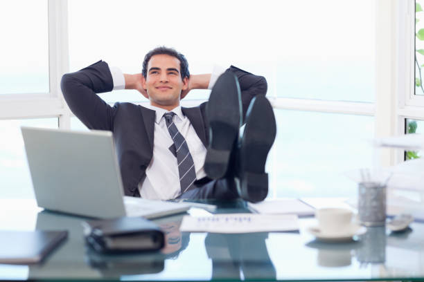 istock Smiling businessman relaxing 826443568
