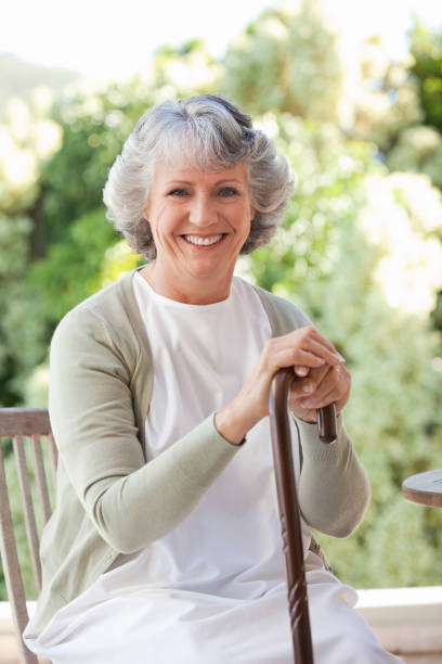 istock Retired woman with her walking stick 826453236