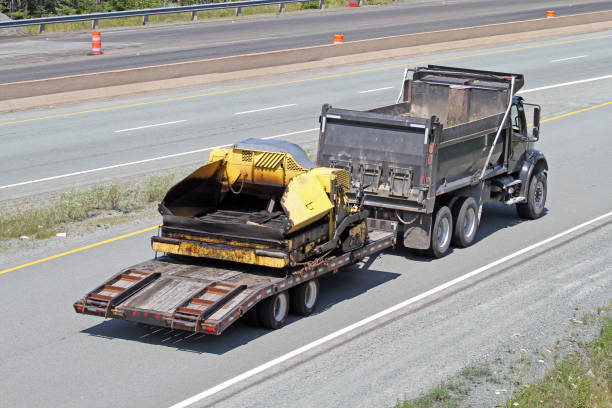 istock Dump Truck With Trailer Hauling Asphalt Paving Machine 826453274