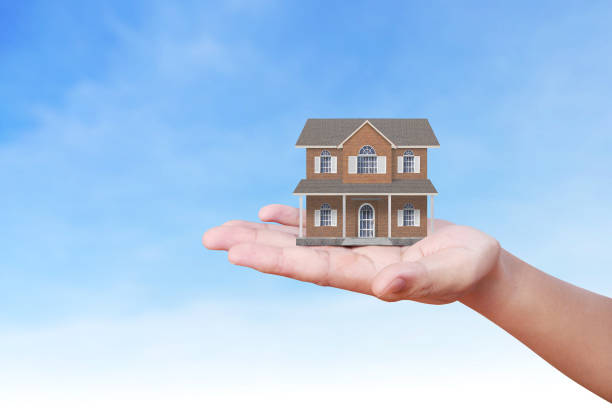 istock Mortgage concept by house from  hand 826459642