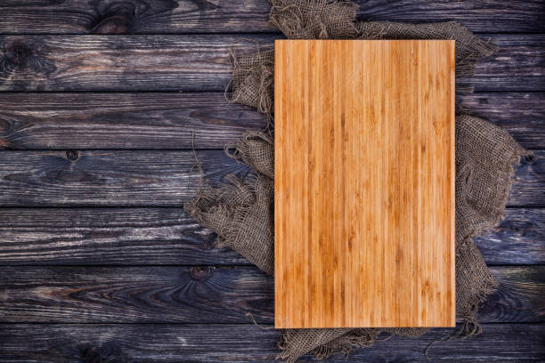 istock Cutting board on dark wood background, top view 826459646