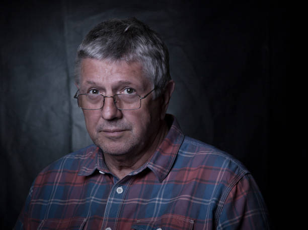 istock senior man with serious expression wearing glasses 826460466