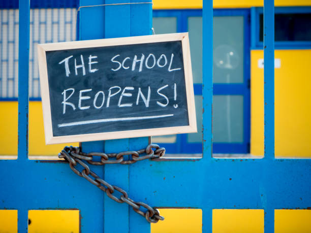 istock a gate school closed and a chalkboard hanged  on it 826464456