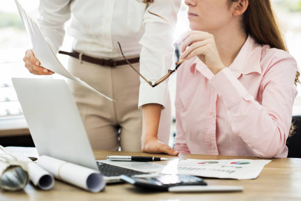 istock Business colleague discussing paperwork graphs 826474856