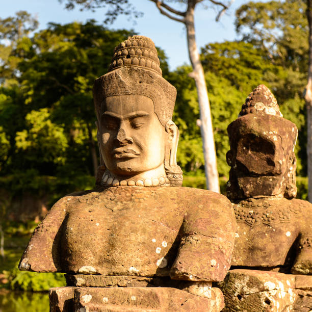 Close-up view of one of the iconic face towers at Bayon Temple, believed to represent either King Jayavarman VII or the bodhisattva Avalokiteshvara. The moss-covered sandstone sculpture reflects the serene expression and architectural mastery of the late 12th-century Khmer Empire.