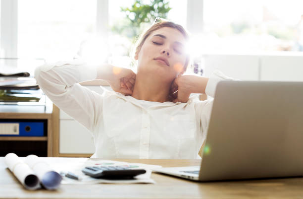 istock Tired businesswoman holding her nape 826475556