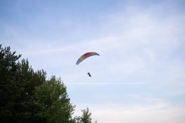 istock Paraglider flying in the air during colorful sunset. 826482818