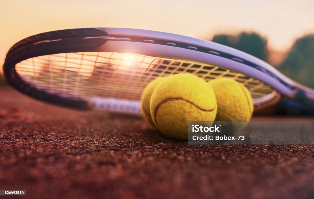 Tennis ball with racket on the tennis court. Sport, recreation concept Tennis game. Tennis ball with racket on the tennis court. Sport, recreation concept Tennis Stock Photo