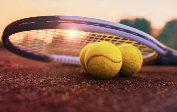 Tennis ball with racket on the tennis court. Sport, recreation concept stock photo