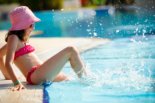 Little girl having fun in swimming pool